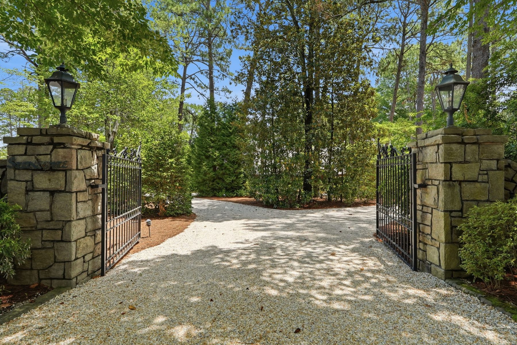 A stone gatehouse under tall pines