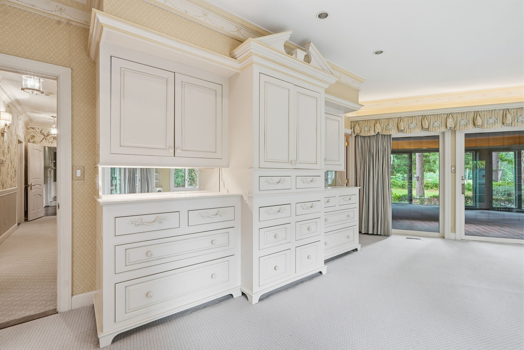 A pale dressing room with french doors to the garden